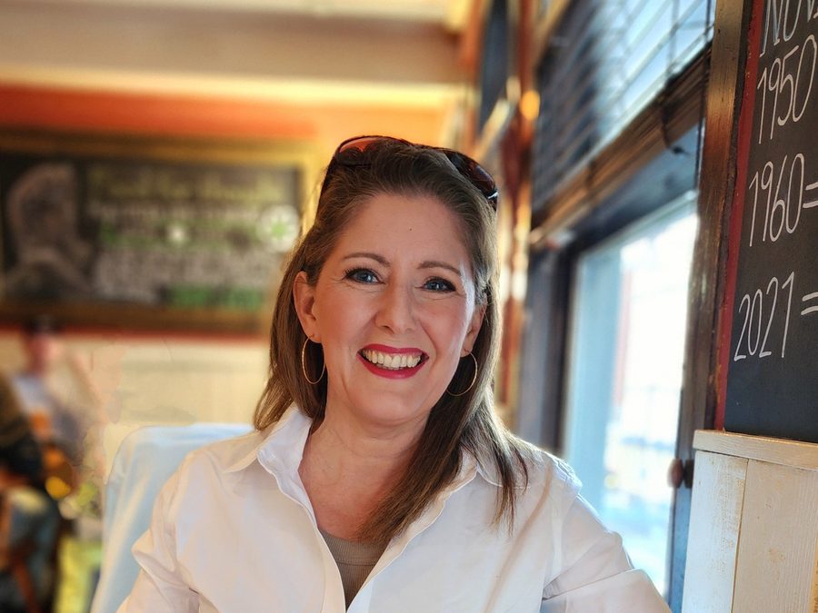 Kay laughing at a restaurant table